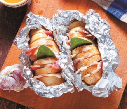 Πατάτες ακορντεόν στο αλουμινόχαρτο με σκορδόλαδο, κασέρι και μπέικον